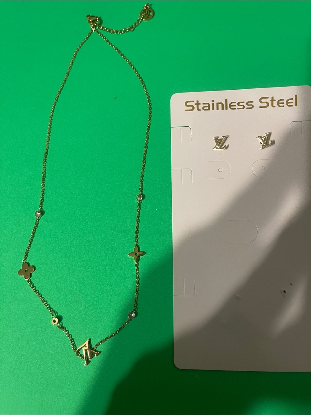 Source Unknown Gold-Tone Logo Pendant Necklace with Floral Motifs